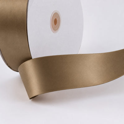 Gold satin ribbon on spool, close-up product image
