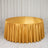 Gold satin round tablecloth on a banquet table with elegant draped backdrop