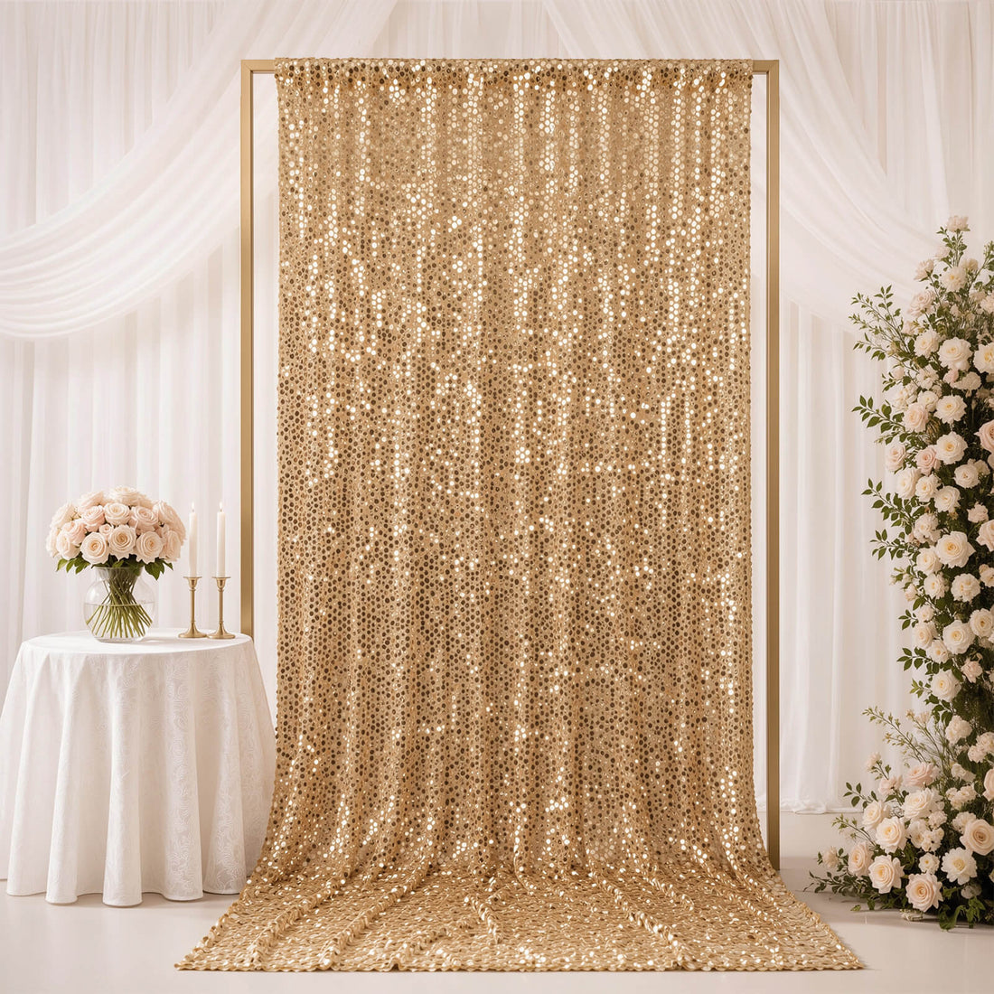 Gold sequin wedding backdrop with white floral decor and draped curtains