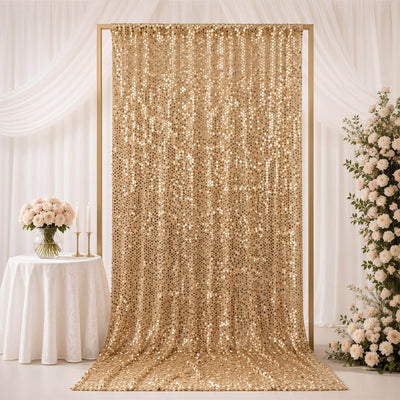 Gold sequin wedding backdrop with white floral decor and draped curtains