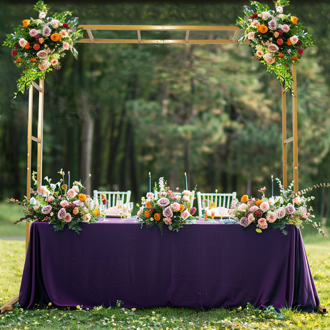 Outdoor wedding reception table adorned with flowers and a purple tablecloth.