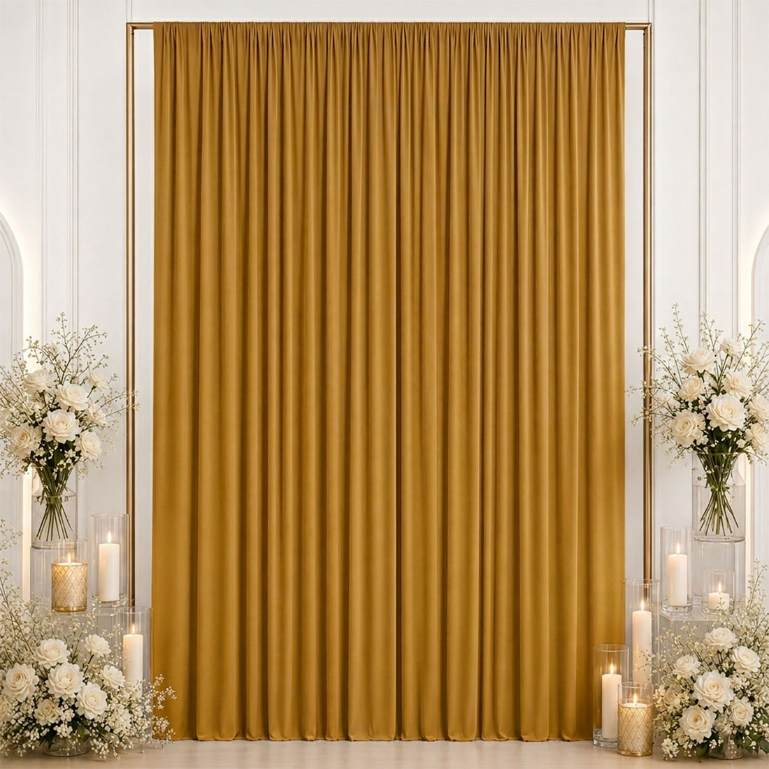 Gold velvet backdrop curtain with white floral arrangements and candles for wedding decor