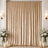 Gold velvet curtain backdrop with floral arrangements and candles indoors