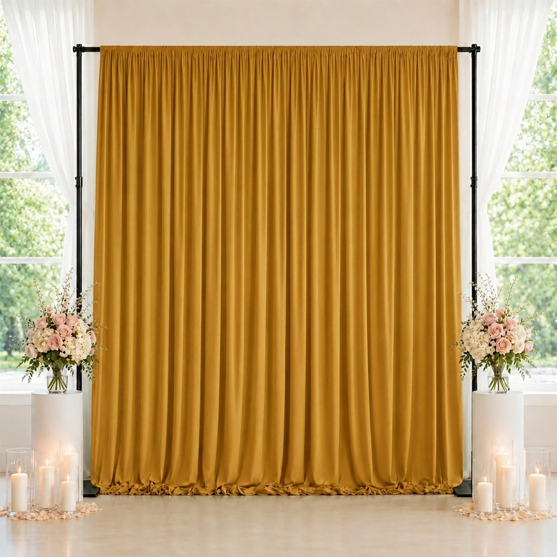 Gold wedding backdrop curtain with floral arrangements and candles
