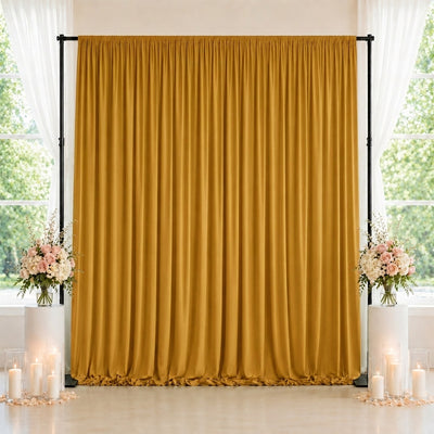 Gold wedding backdrop curtain with floral arrangements and candles