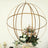 Gold metal globe planter with flowers and greenery.