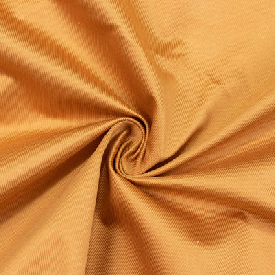 Golden ribbed fabric swirl texture background