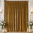 Golden velvet curtains with candles and white floral arrangements in an elegant room