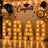 Graduation party backdrop with gold GRA letters and black-and-gold balloons