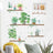 Decorative wall art featuring plants and gardening accessories in a modern setting.