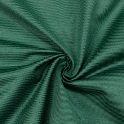 Green ribbed fabric texture swirled into a spiral close-up
