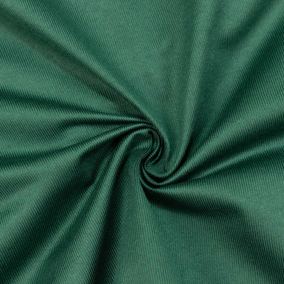 Green ribbed fabric texture with spiral fold close-up#whtbkgd
