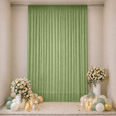 Green sheer curtain wedding backdrop with floral arrangements and balloons