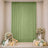 Green sheer curtain wedding backdrop with floral arrangements and balloons