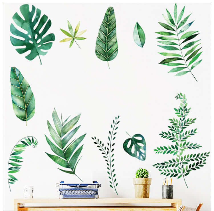 Green leaf wall decals arranged artistically above a desk with a typewriter.