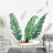 Tropical leaf wall decals in a stylish living room setting.