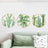 Cactus wall art set with green plants in circular frames, enhancing modern decor.
