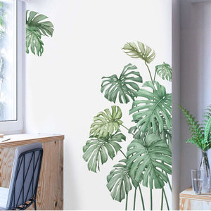 Green monstera wall decals in a modern interior setting.