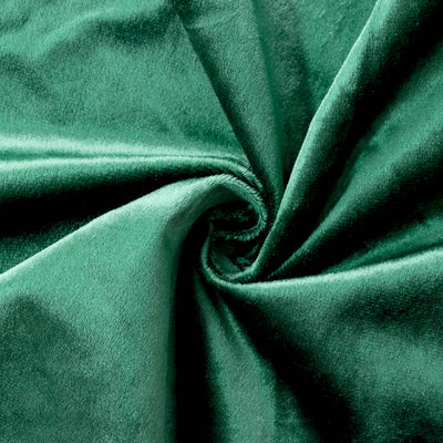 Green velvet fabric texture with soft folds and swirl pattern#whtbkgd