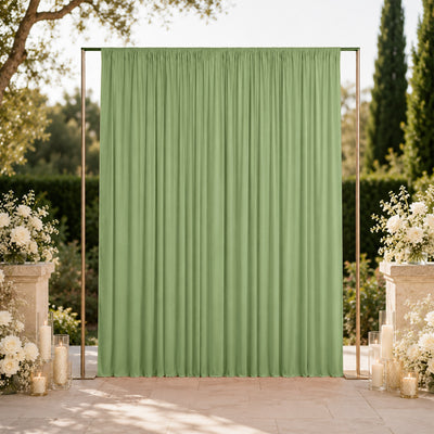 Green wedding backdrop curtain with floral arrangements and candles outdoors