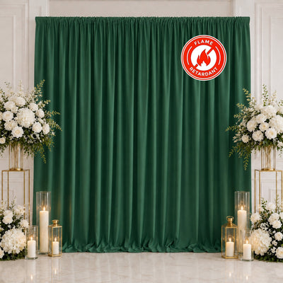Green wedding backdrop with white floral arrangements and candle decor, flame retardant