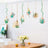 Hanging geometric planters with succulents in a modern kitchen setting.