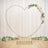 Gold heart-shaped backdrop with floral decoration for events.