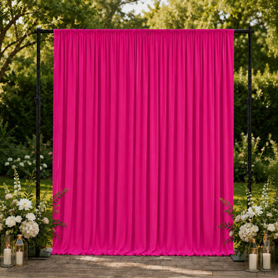 Hot pink event backdrop curtain with floral arrangements outdoors