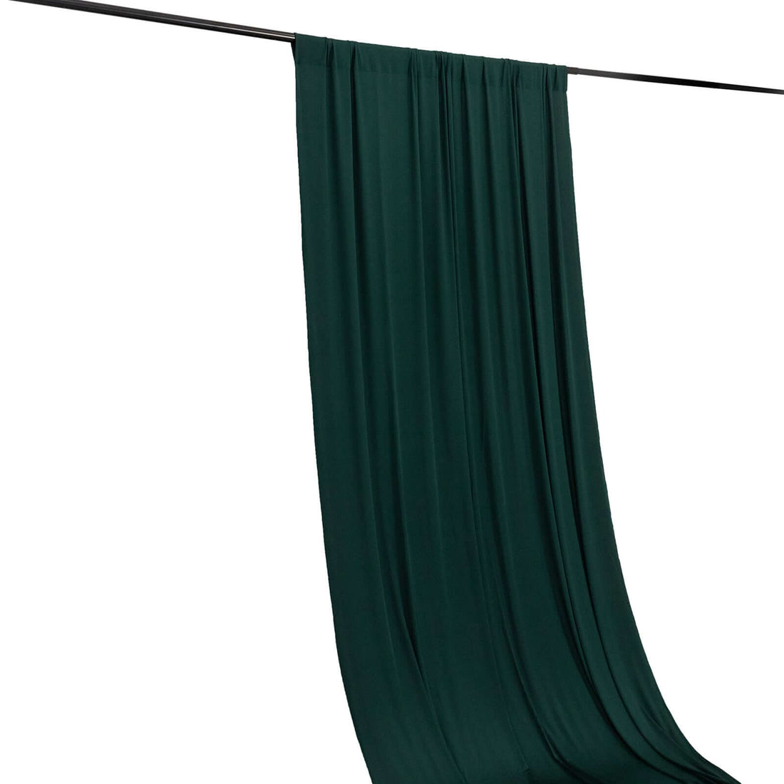 Dark green fabric draped elegantly on a rod