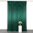 Green draped fabric backdrop with decorative pleats and floral arrangement.