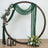 Decorative wedding arch with greenery and flowers, featuring lanterns and draped fabric.
