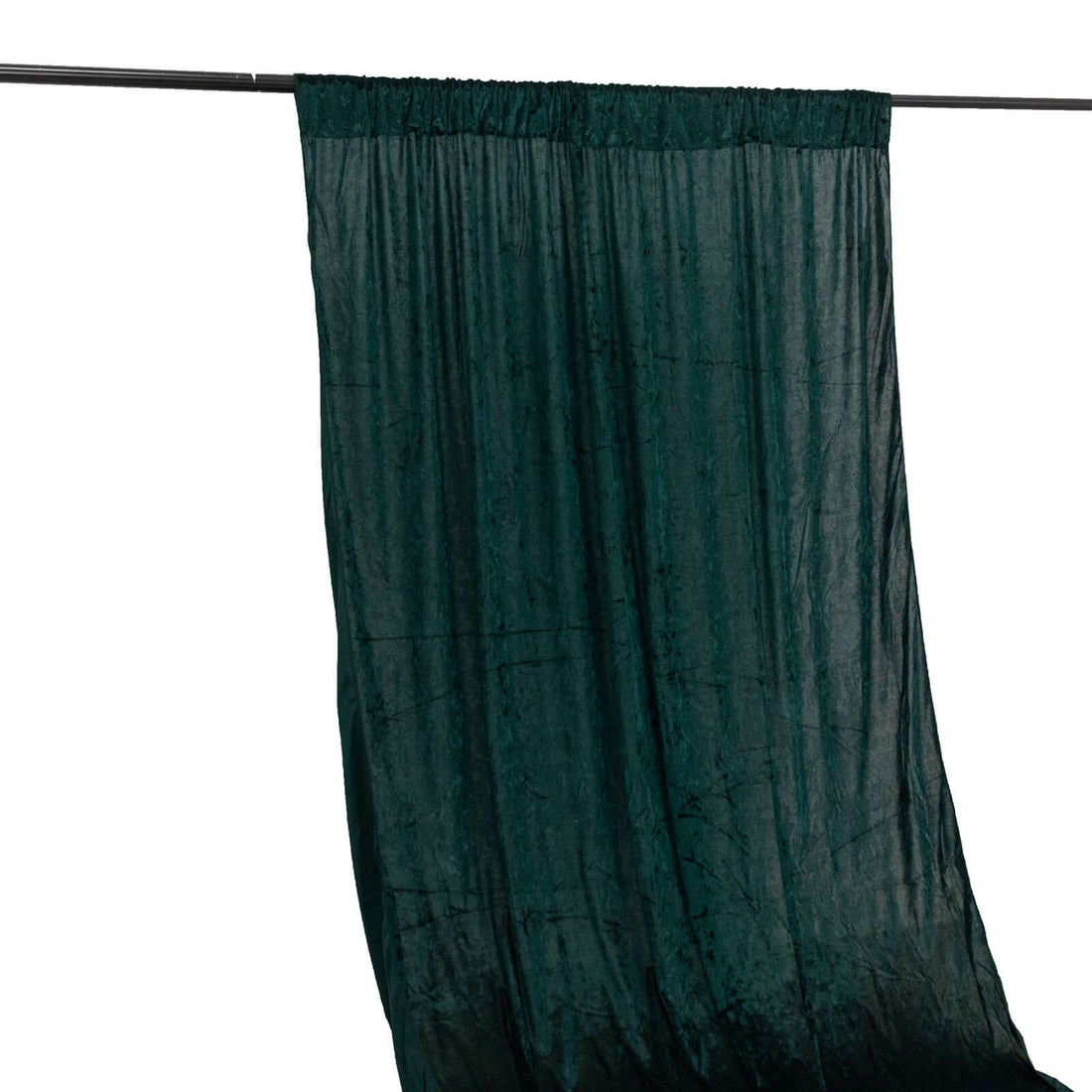 Dark green textured curtain hanging from a rod