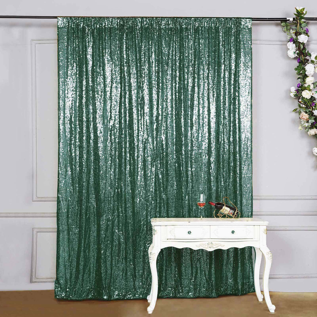 Green sequin backdrop curtain with vintage white table and decor.