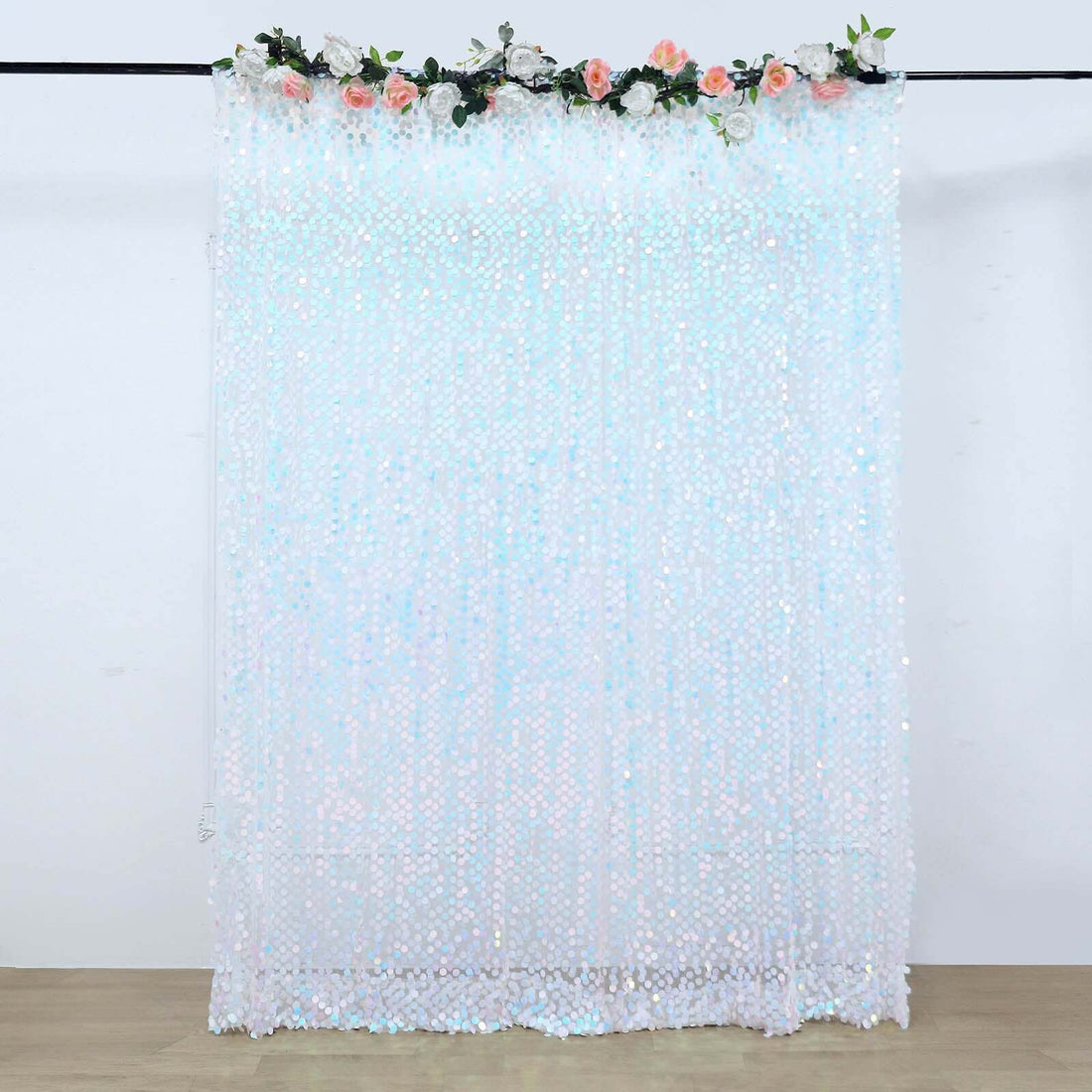 Sparkling sequin backdrop with floral accents for events and photography.