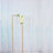 Floral arrangement in a modern display frame against a shimmering backdrop.