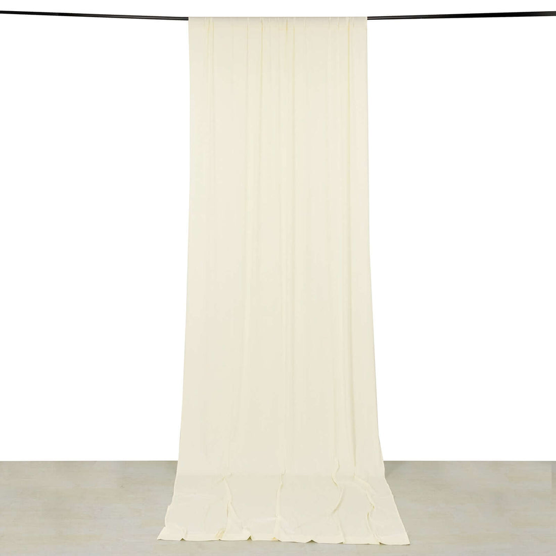 Cream drapery fabric hanging from a rod against a white background