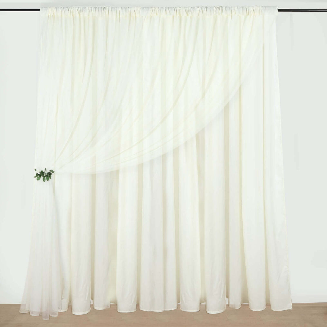 Sheer white curtain draping elegantly on a rod.