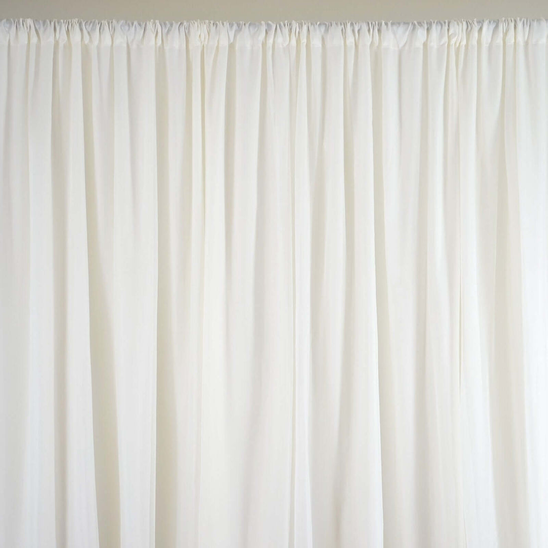 White sheer curtain panel with soft draping texture.