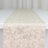 Ivory jacquard table runner on white table, elegant textured fabric close-up