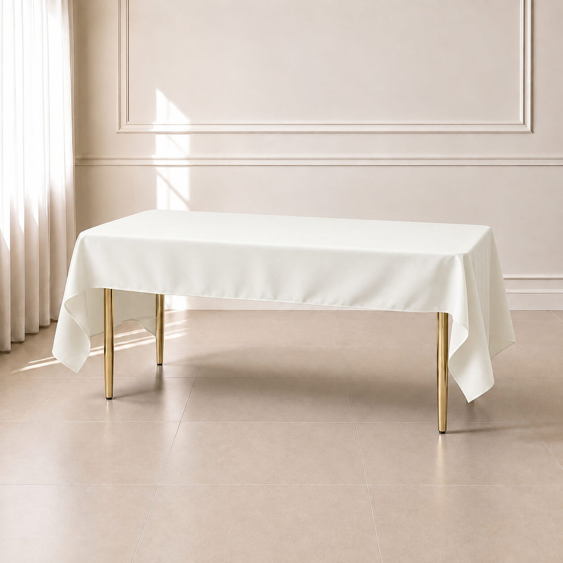 Ivory polyester tablecloth 50"x120" on a wooden table.