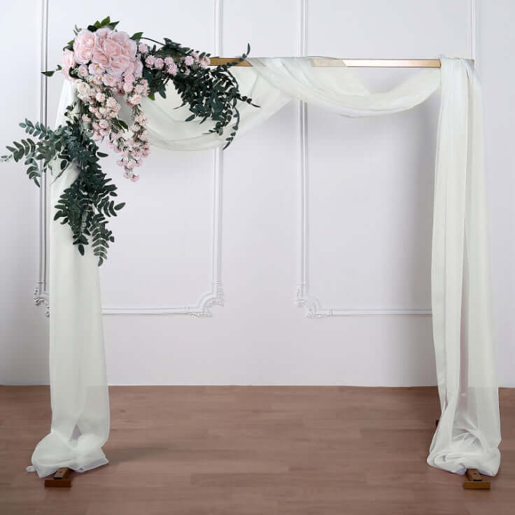 Floral wedding arch with draped fabric and greenery