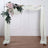 Floral wedding arch with draped fabric and greenery
