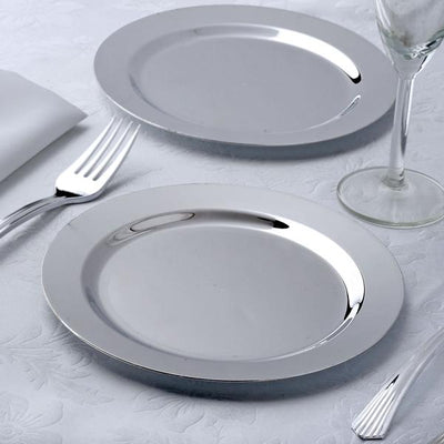 Elegant silver serving plates on a textured tablecloth.
