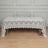 Elegant lace tablecloth draped over a table in a studio setting.