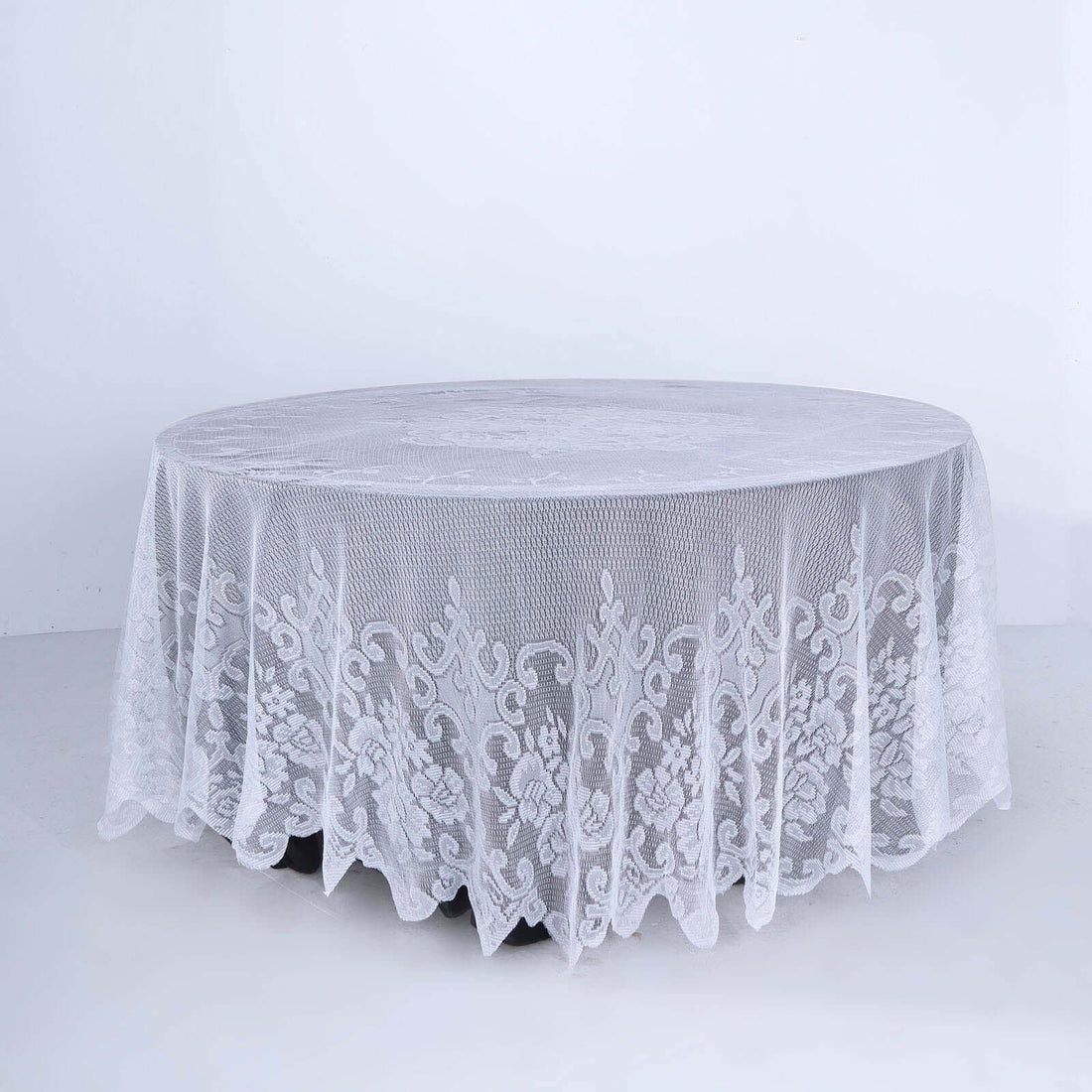 White round lace tablecloth draped over table