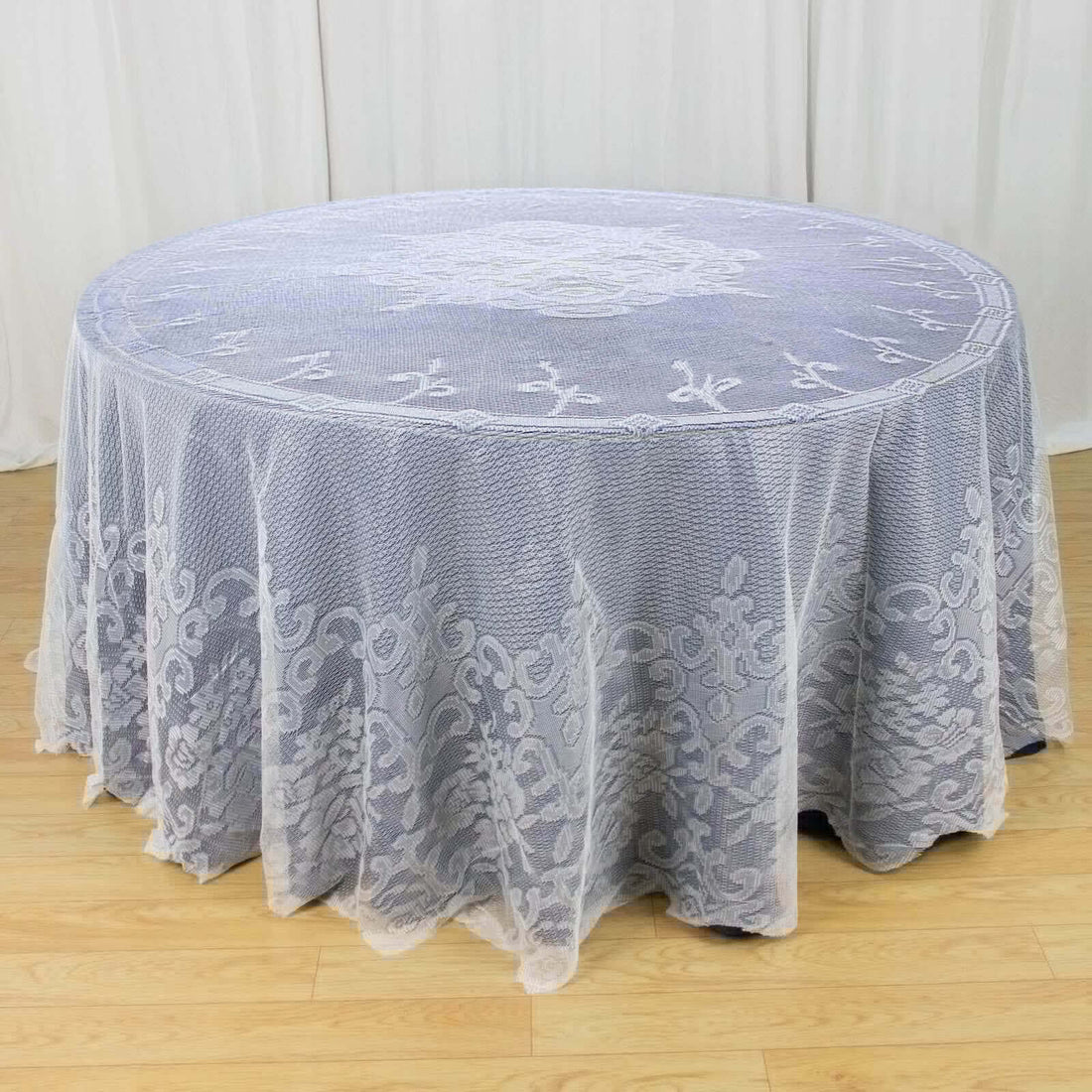 Lace tablecloth with intricate design on a round table
