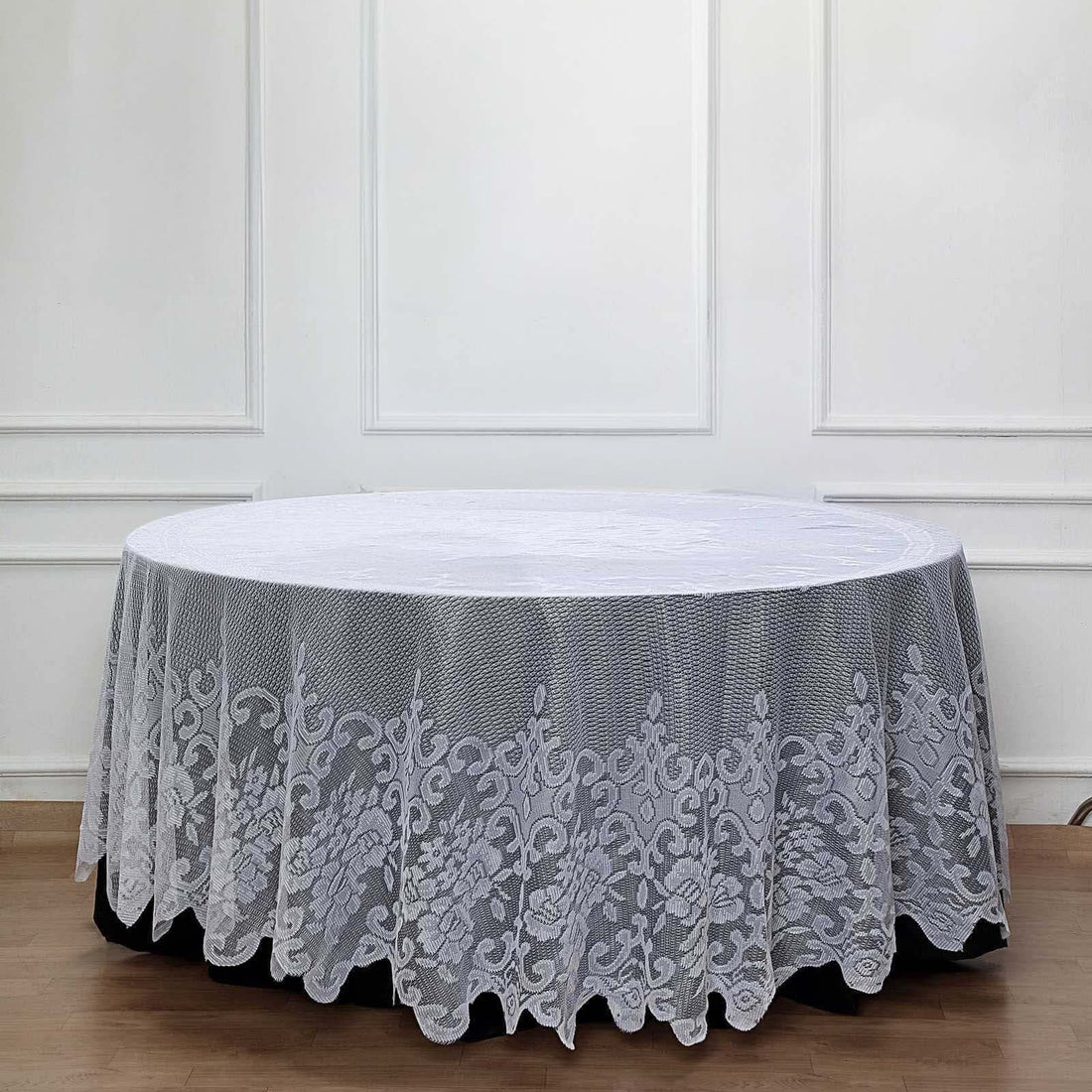 Round lace tablecloth with floral design on a table.