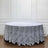Round lace tablecloth with floral design on a table.