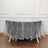 Lace tablecloth draped over an oval table in a bright room.