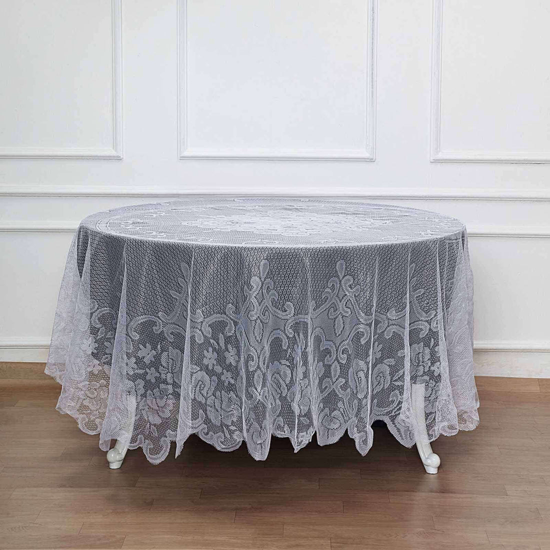 Gray lace tablecloth draped elegantly over an oval table.